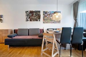 a living room with a couch and a table at Blackforest Perla in Höchenschwand +29 photos