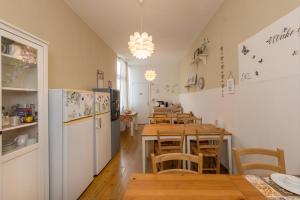 a kitchen and dining room with tables and a refrigerator at Piccolo Paradiso - Montenero in Montenero
