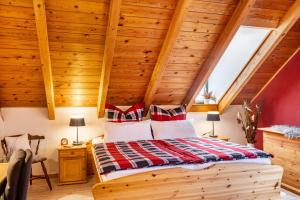 a bed in a room with wooden ceilings at Dachwohnung Im Landhausstil in Meiningen