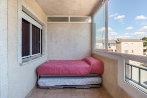 a small balcony with two bean bags on a window at Casa Pepe in Los Narejos +12 photos