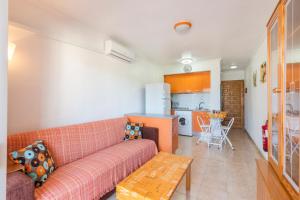 a living room with a couch and a kitchen at Casa Pepe in Los Narejos
