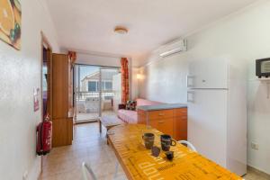 a kitchen with a table and a refrigerator at Casa Pepe in Los Narejos