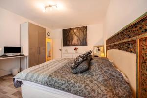 a bedroom with a large bed and a television at Ferienwohnung Bettersleepat8 in Limburg an der Lahn