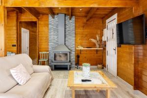 a living room with a couch and a fireplace at Cortijo la Jimena 2 in Benablón