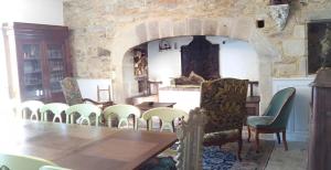 a dining room with a table and chairs at Chateau De Chaunac in Naves