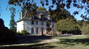 a large white house with a blue roof at Chateau De Chaunac in Naves