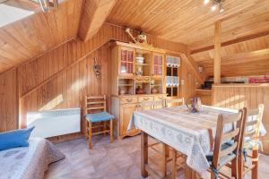 a kitchen with a table and chairs in a room at Gite Campbieil - Gavarnie in Gèdre
