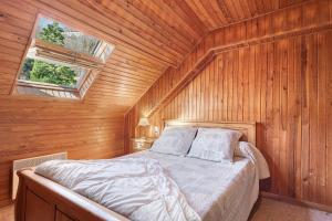 a bedroom with a bed in a wooden wall at Gite Campbieil - Gavarnie in Gèdre