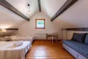 a large room with two beds and a table at Chalet Sambuy - Val de Tamié in Faverges