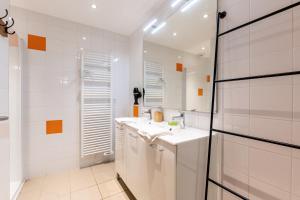 a white bathroom with two sinks and a mirror at Chalet Sambuy - Val de Tamié in Faverges +21 photos