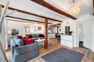 a living room with a couch and a table at Vogtshaus de Luxe in Gernsbach +26 photos