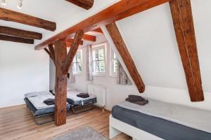 a bedroom with two beds and wooden beams at Vogtshaus de Luxe in Gernsbach