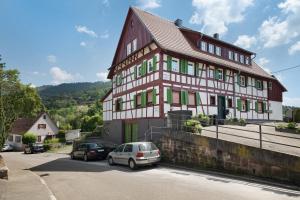 a large house with cars parked in front of it at Vogtshaus de Luxe in Gernsbach