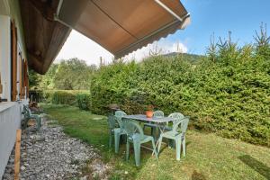 a table and chairs sitting under an umbrella at Gite des Granges in Tréminis