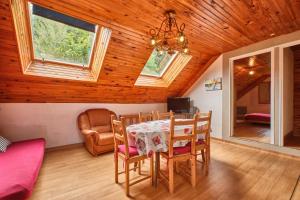 a dining room with a table and chairs at Gite des Granges in Tréminis