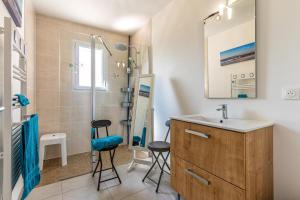 a bathroom with a sink and two stools at Villa du Lac - Gastes in Gastes +15 photos