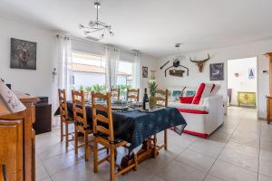 a kitchen and dining room with a table and chairs at Villa du Lac - Gastes in Gastes