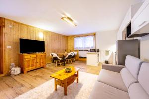 a living room with a couch and a table at Casa Fiocco di Neve in Vigo di Cadore