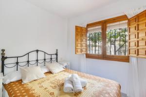 a bedroom with a bed with two towels on it at Moreras in Puerto de Mazarrón +12 photos