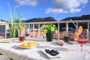 a table with food and wine glasses on a balcony at T2 Le Panorama in Cassis