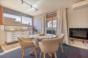 a dining room with a glass table and chairs at Terra Nova Penthouse in Lajita