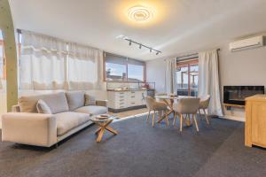 a living room with a couch and a table at Terra Nova Penthouse in Lajita