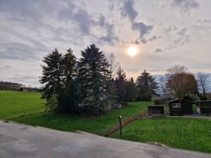 a view of a field with the sun in the sky at Ferienwohnung Arnsberger Wald in Möhnesee