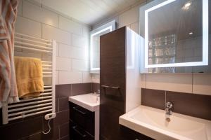 a bathroom with a sink and a mirror at Gite Au pied du Pic du Midi in Campan +15 photos