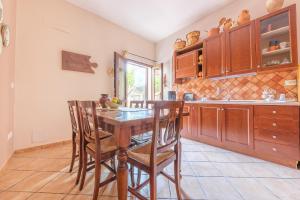 a kitchen with a wooden table and chairs at La Casa dei Limoni in Gaggi +11 photos