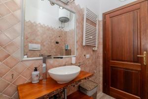 a bathroom with a sink and a mirror at Attico Stella Maris in Palau +26 photos