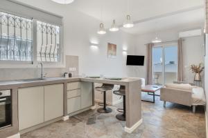 a kitchen with a table and a living room at Ariston House in Porto Heli