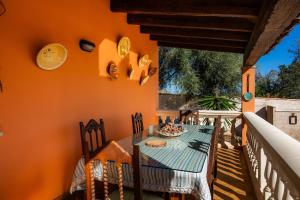 a dining room with a table and chairs on a balcony at Can Pota in Portocolom