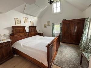 a bedroom with a large bed and wooden furniture at Lorenzfranzl in Sankt Oswald ob Eibiswald