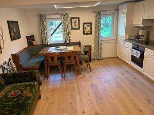 a kitchen and living room with a table and a couch at Lorenzfranzl in Sankt Oswald ob Eibiswald