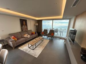 a living room with a couch and a table at Blue infinity 7 in Cumbre del Sol