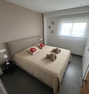 a bedroom with a bed with two pillows and a window at Blue infinity 7 in Cumbre del Sol +17 photos