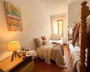 a small room with a bed and a couch at Costa Arenal 5 in Arenal d'en Castell
