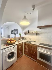 a kitchen with a sink and a washing machine at Costa Arenal 5 in Arenal d'en Castell +8 photos