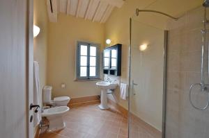 a bathroom with two toilets and a glass shower at Appartamento Cipresso in Trequanda +20 photos