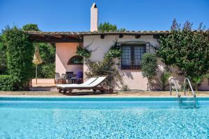 a house with a swimming pool in front of a house at Villa Fiori 3 in Is Molas  +19 photos