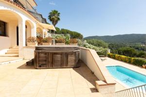 a house with a swimming pool next to a house at Casa Vista Del Mar in Calonge