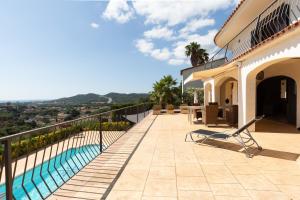a balcony of a house with a swimming pool at Casa Vista Del Mar in Calonge