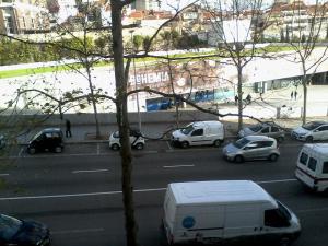 a view of a street with cars parked on the road at Metro-Apartment RNAL nº35375 AL-Chamada para a rede móvel nacional in Porto +5 photos
