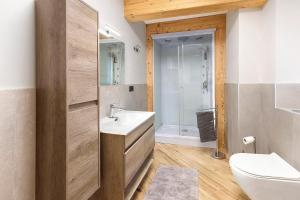 a bathroom with a white sink and a toilet at Appartamento Via Livigno in Isolaccia +15 photos