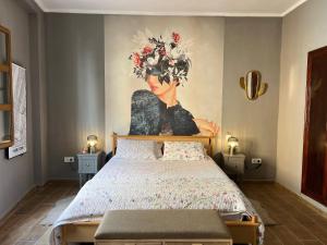 a bedroom with a painting of a woman at La Bonita de Pego in Pego