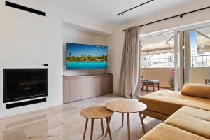 a living room with a couch and a tv at Casa Sunshine in Marbella