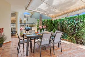 a dining room with a table and chairs on a patio at Casa Sunshine in Marbella
