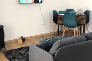 a living room with a couch and a table at Charming House Secret Rose in Flor da Rosa
