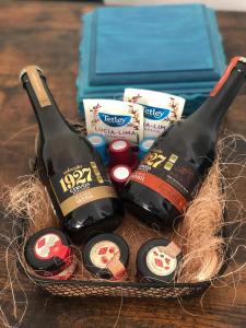 two bottles of wine in a basket on a table at Charming House Secret Rose in Flor da Rosa