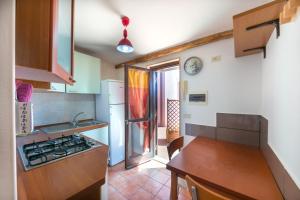 a kitchen with a sink and a stove top oven at Villa Roberta Marina di Campo in Marina di Campo